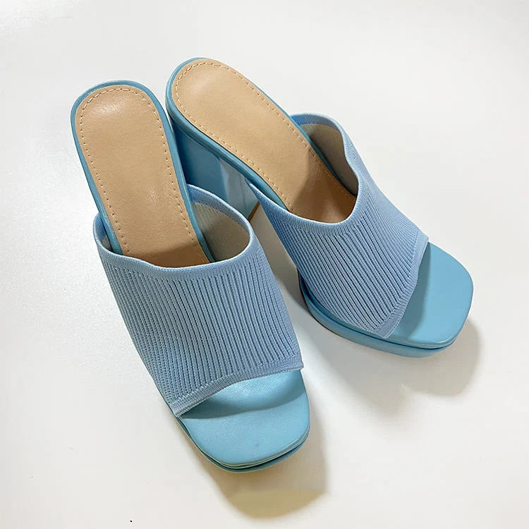 Pair of light blue open-toe sandals on a white background