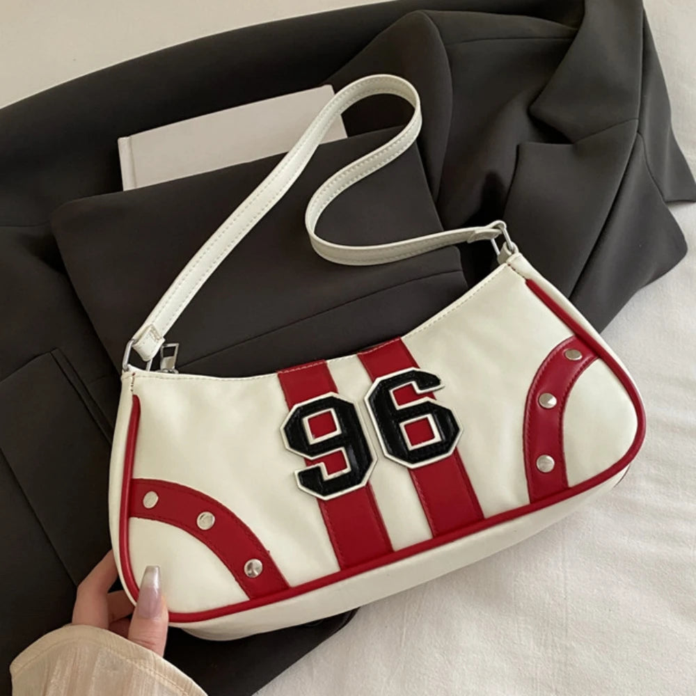 White handbag with red stripes and black number '96' held by a person.