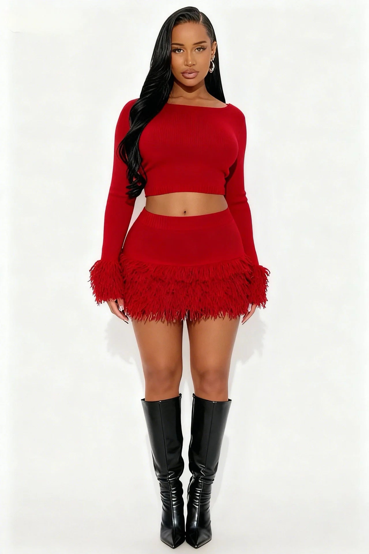 Woman wearing a red outfit with feathered skirt and black boots on a white background